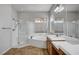 Bathroom featuring glass-enclosed shower, soaking tub, and double sink vanity at 8370 Unicorn St, Las Vegas, NV 89131