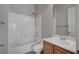 Bright bathroom with a vanity, combined shower-tub, and white tile surround at 8370 Unicorn St, Las Vegas, NV 89131