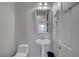 Cozy half-bathroom with a pedestal sink, toilet, and neutral color scheme at 8370 Unicorn St, Las Vegas, NV 89131