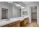 Bathroom featuring double sinks, a make up vanity, and an oversized mirror giving a luxurious and functional space at 8370 Unicorn St, Las Vegas, NV 89131