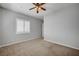 Bedroom featuring a ceiling fan, carpet, and a shuttered window for natural light at 8370 Unicorn St, Las Vegas, NV 89131