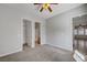 Bedroom with carpet flooring, ceiling fan, and access to bathroom and living areas at 8370 Unicorn St, Las Vegas, NV 89131