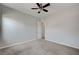 Spacious bedroom with plush carpet, ceiling fan, and ample natural light at 8370 Unicorn St, Las Vegas, NV 89131