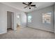 Large bedroom with neutral carpet, ceiling fan and view of the attached bathroom at 8370 Unicorn St, Las Vegas, NV 89131