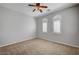 Spacious bedroom with large windows, plantation shutters, and a modern ceiling fan at 8370 Unicorn St, Las Vegas, NV 89131