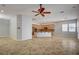 Open-concept kitchen and living area with a ceiling fan and tile flooring throughout at 8370 Unicorn St, Las Vegas, NV 89131