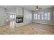 Inviting living room featuring tile flooring, a fireplace, and large shuttered windows at 8370 Unicorn St, Las Vegas, NV 89131