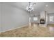 Spacious living area with tile flooring, fireplace, open layout and neutral walls at 8370 Unicorn St, Las Vegas, NV 89131