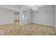 Bright living room featuring tile flooring, neutral walls, and an elegant chandelier at 8370 Unicorn St, Las Vegas, NV 89131
