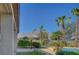 Palm trees surround the pool in this backyard with a pergola providing shade at 8370 Unicorn St, Las Vegas, NV 89131