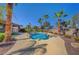 Beautiful backyard with a sparkling swimming pool, surrounded by lush palm trees and tropical landscaping at 8370 Unicorn St, Las Vegas, NV 89131