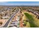 The aerial view captures the homes nestled within a vibrant community, adjacent to a golf course at 9425 Villa Ridge Dr, Las Vegas, NV 89134
