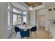 Charming breakfast nook with a round table, stylish blue chairs, and bright natural lighting at 9425 Villa Ridge Dr, Las Vegas, NV 89134