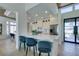 Modern kitchen with stainless steel appliances, white cabinets, island seating, and open floor plan at 9425 Villa Ridge Dr, Las Vegas, NV 89134