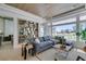 Bright living room with a modern gray sofa, open shelving, and a large window view at 9425 Villa Ridge Dr, Las Vegas, NV 89134