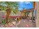 Backyard features a pergola, a small palm tree, and a patio with chairs at 9557 Cabot Falls Ave, Las Vegas, NV 89149