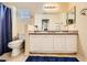 Bright bathroom features a double sink vanity with granite countertops and a large mirror at 9557 Cabot Falls Ave, Las Vegas, NV 89149