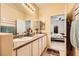 Bathroom with double sinks, granite countertops and view to the bedroom at 9557 Cabot Falls Ave, Las Vegas, NV 89149