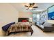 Bright bedroom with a ceiling fan and window offering abundant natural light and a comfortable seating area at 9557 Cabot Falls Ave, Las Vegas, NV 89149