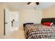 Inviting bedroom with a ceiling fan and easy access to the adjoining bathroom at 9557 Cabot Falls Ave, Las Vegas, NV 89149