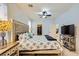 Inviting bedroom featuring a king-sized bed, ceiling fan, and side tables with lamps at 9557 Cabot Falls Ave, Las Vegas, NV 89149
