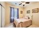 Charming bedroom with ceiling fan, window with blinds and a cozy bed with rose colored bedding at 9557 Cabot Falls Ave, Las Vegas, NV 89149