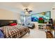 Bright bedroom with a ceiling fan and window offering abundant natural light and a comfortable seating area at 9557 Cabot Falls Ave, Las Vegas, NV 89149