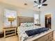 Comfortable bedroom featuring a ceiling fan and comfortable king-sized bed with lamps and nightstands at 9557 Cabot Falls Ave, Las Vegas, NV 89149