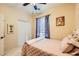 Cozy bedroom with soft lighting, a ceiling fan, and a window with curtains for privacy and comfort at 9557 Cabot Falls Ave, Las Vegas, NV 89149