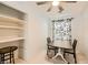 Bonus room features a ceiling fan, a window with floral curtains and a small table with chairs at 9557 Cabot Falls Ave, Las Vegas, NV 89149