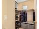 Walk-in closet with shelving, hanging racks, and an ottoman at 9557 Cabot Falls Ave, Las Vegas, NV 89149
