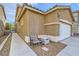 Charming home featuring a two-car garage, sidewalk and outdoor bench at 9557 Cabot Falls Ave, Las Vegas, NV 89149