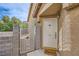 Charming front door with security gate, potted plants, and a 'home' welcome mat at 9557 Cabot Falls Ave, Las Vegas, NV 89149