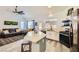 Bright living room featuring an open floor plan, kitchen appliances and outdoor view at 9557 Cabot Falls Ave, Las Vegas, NV 89149