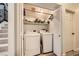 Laundry room with side-by-side washer and dryer and shelving with supplies at 9557 Cabot Falls Ave, Las Vegas, NV 89149