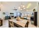 Bright living room featuring a dining table, open floor plan, and beach-themed accents at 9557 Cabot Falls Ave, Las Vegas, NV 89149