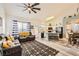 Spacious living room open to the kitchen, luxury vinyl flooring, and nautical decor at 9557 Cabot Falls Ave, Las Vegas, NV 89149