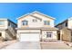 Two-story home featuring a two-car garage and low maintenance front yard landscaping at 9692 Waukegan Ave, Las Vegas, NV 89148