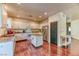 Well-lit kitchen with white cabinets, center island, stainless steel appliances, and wood floors at 9692 Waukegan Ave, Las Vegas, NV 89148