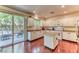 Bright kitchen with white cabinets, center island, and sliding glass door to the patio at 9692 Waukegan Ave, Las Vegas, NV 89148
