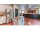 Spacious kitchen with stainless steel refrigerator opening to the living room and dining area at 9692 Waukegan Ave, Las Vegas, NV 89148