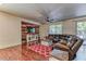 Open living area with modern decor, hardwood floors, and comfortable sectional sofa at 9692 Waukegan Ave, Las Vegas, NV 89148