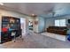 Spacious living room with neutral walls, a ceiling fan, and seamless access to other parts of the home at 9692 Waukegan Ave, Las Vegas, NV 89148