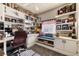 Well-lit office space featuring custom built-ins, desk, carpet, and comfortable seating, perfect for remote work and organization at 9692 Waukegan Ave, Las Vegas, NV 89148