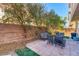 Private backyard patio with brick pavers, mature trees, and outdoor seating, perfect for relaxation at 9692 Waukegan Ave, Las Vegas, NV 89148