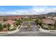 Aerial view of a gated community entrance with well-maintained landscaping and mountain views at 9993 Birch Knoll Ave, Las Vegas, NV 89166