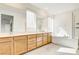 Bright Primary bathroom with double vanity, tub and glass enclosed shower at 9993 Birch Knoll Ave, Las Vegas, NV 89166