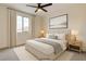 Bright bedroom featuring a large window, soft carpet, and tasteful decor at 9993 Birch Knoll Ave, Las Vegas, NV 89166