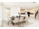 Bright dining room with seating for six, modern decor, and views into the kitchen at 9993 Birch Knoll Ave, Las Vegas, NV 89166
