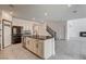 Bright kitchen boasts stainless steel appliances, granite counters, and a center island with a sink at 9993 Birch Knoll Ave, Las Vegas, NV 89166
